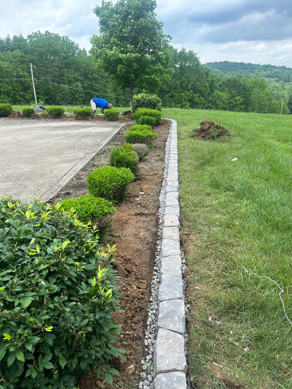 Stone edging and landscape bed install in progress by LPSI crew