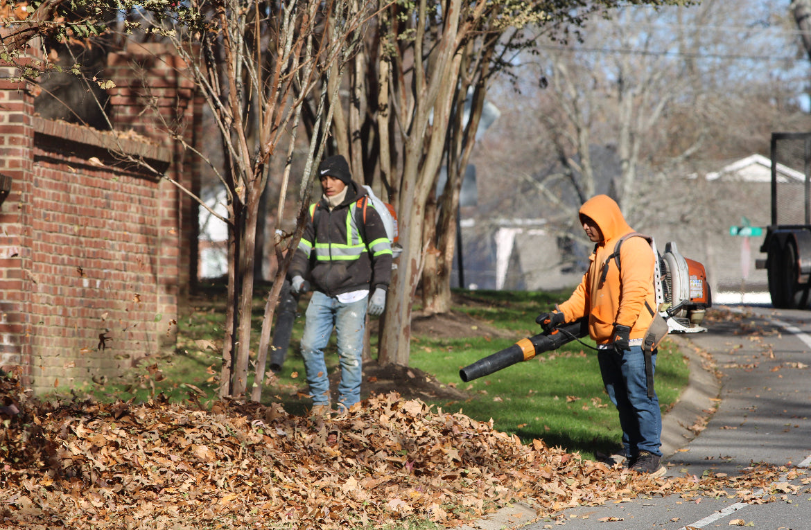 LPSI leaf crew with backpack blowers and Griffin vacuum trailer during fall cleanup